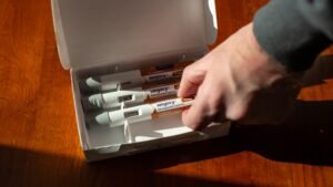 Stocks making the biggest moves midday: NVO, PLTR, AES, RKT